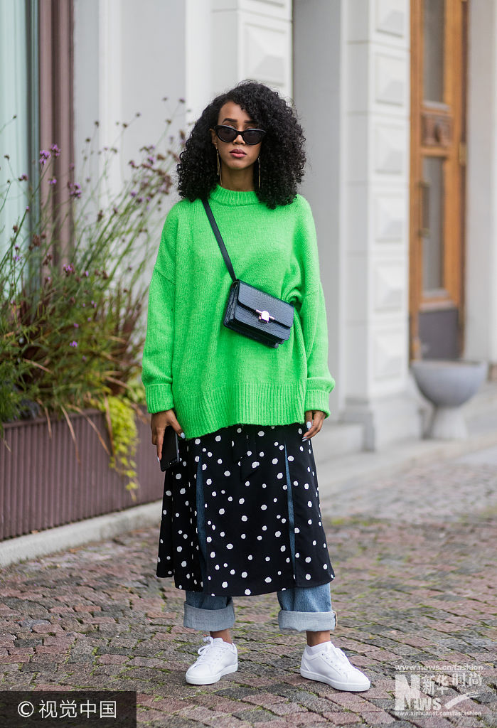 ***_***STOCKHOLM, SWEDEN - AUGUST 31: A guest wearing a green knit, skirt over denim jeans, sneaker outside Valerie on August 31, 2017 in Stockholm, Sweden. (Photo by Christian Vierig/Getty Images)